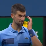 Novak Djokovic looks stunned on the court during his surprising defeat to Alexei Popyrin at the US Open.