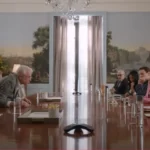 Cast of Only Murders in the Building standing together in front of their apartment building