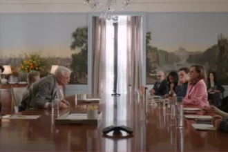 Cast of Only Murders in the Building standing together in front of their apartment building